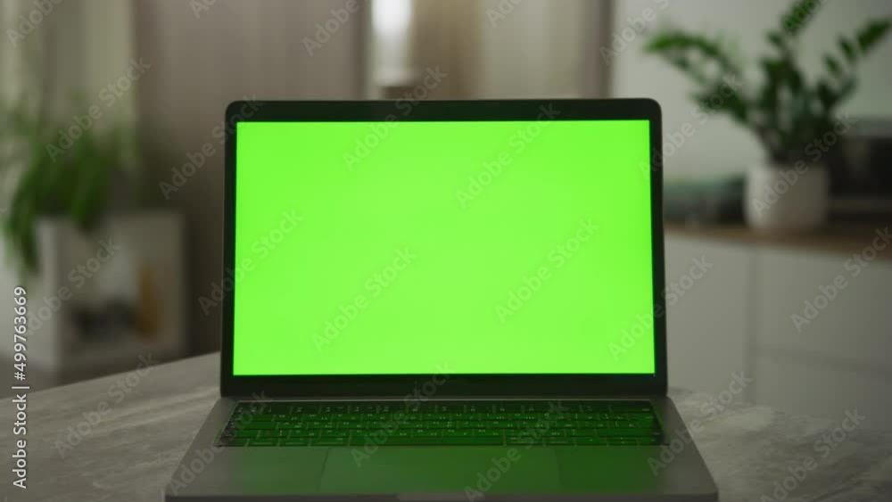 Slow optical zoom in into a laptop computer screen with a green chromakey on it Slow optical zoom in into a laptop computer screen with a green chromakey on it