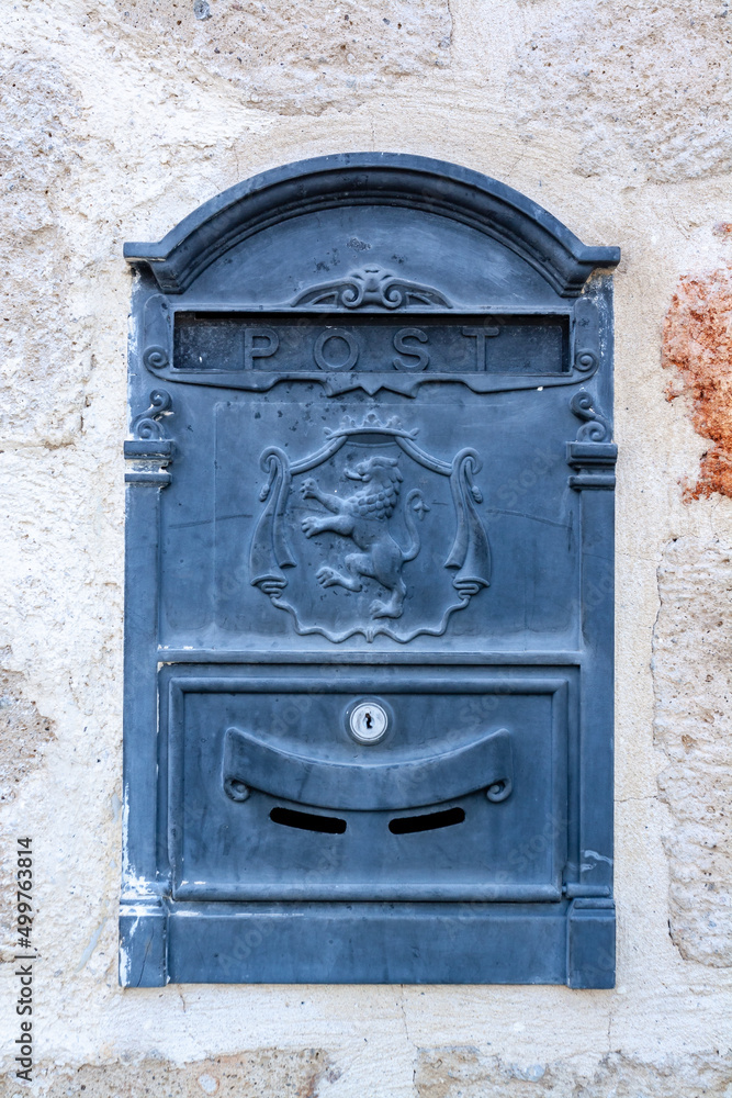 Old mailbox with lion on the coat of arms built into the wall. Old mailbox with lion on the coat of arms built into the wall.