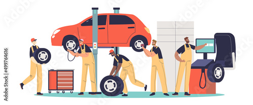 Workers changing tire for car. Auto mechanics fixing service with technicians working on tire mount