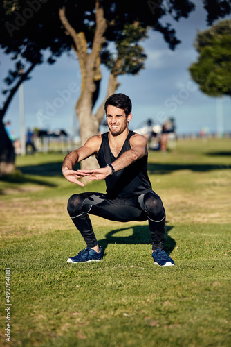 No pain, no gain. Shot of a young man in gymwear working out in a park.