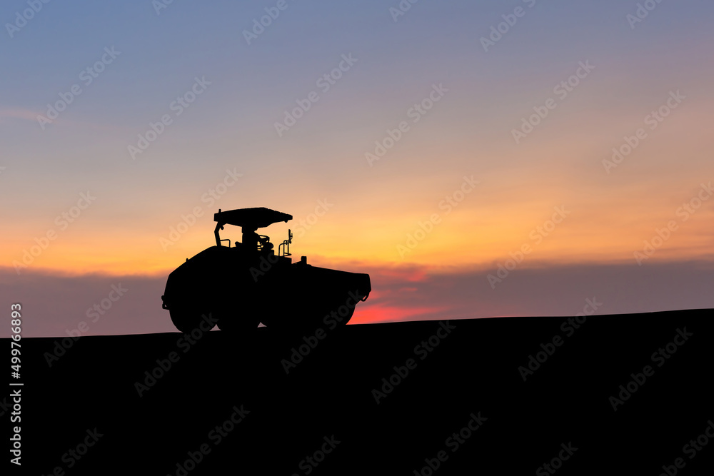 Fototapeta premium Silhouette of Compactors at road construction site, vibratory Road roller and asphalt paver, heavy equipment for road construction