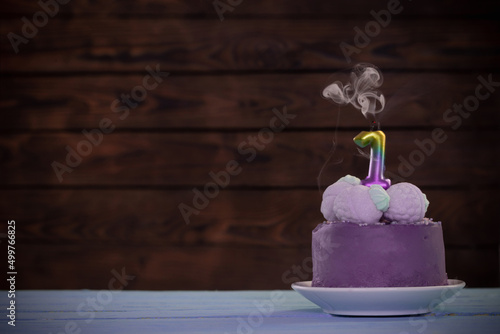 birthday cake with candle on dark wooden background