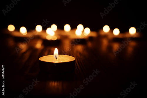 Fotografia Burning candle over black background