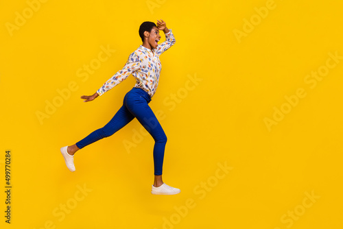 Full body profile portrait of excited person hand forehead look watch empty space isolated on yellow color background © deagreez