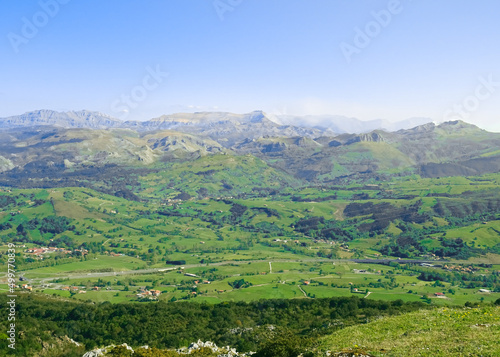 Views of the green Pas region valleys (Valles Pasiegos) and its peaks: Fraile peak (Pico Fraile) and Castro Valnera peak (Pico Castro Valnera). At Peña Cabarga Llen peak in Santander, Cantabria.