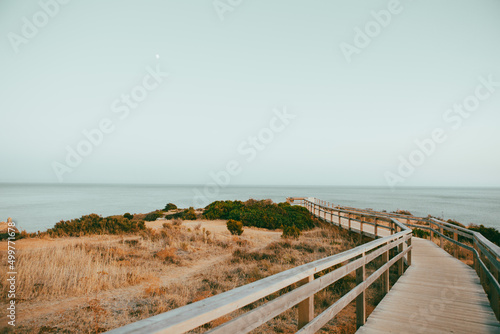 Coastal walkway along cliffs in summer, Algarve, Portugal photo