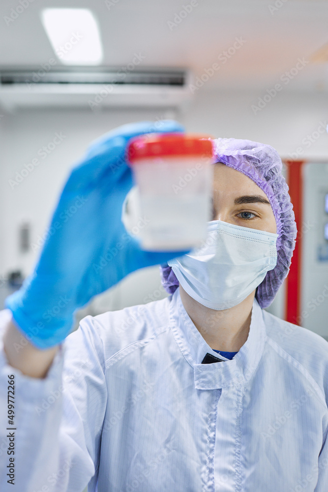 A girl scientist checks a sample for research A girl scientist checks a sample for research