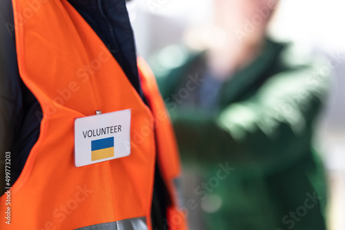 Volunteer registring Ukrainian refugees at train station, close-up photo