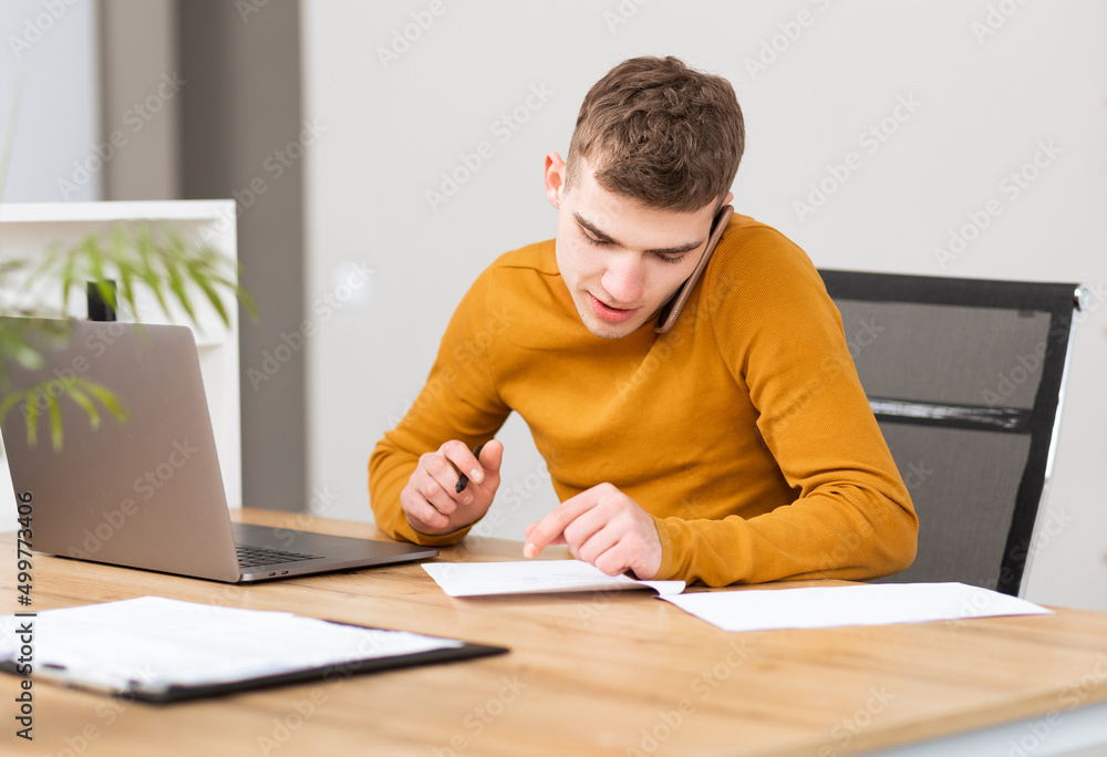 young successful man working with documents in the office young successful man working with documents in the office