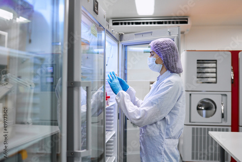 Wallpaper Mural A girl scientist checks a sample for research Torontodigital.ca