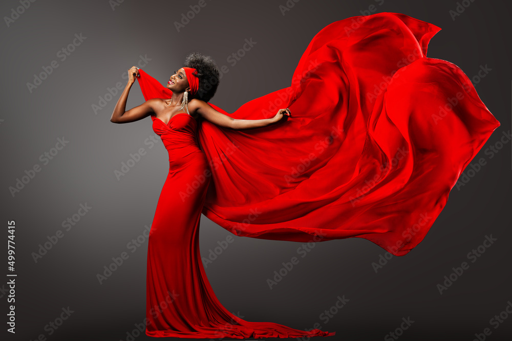 Fashion African Woman in Red Dress with Silk Scarf flying on Wind. Happy  Dark Skinned Model
