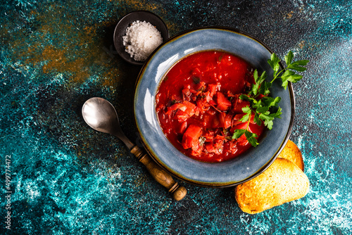 Overhead view of a bowl of traditional Ukrainian beetroot soup (borscht) with toast photo