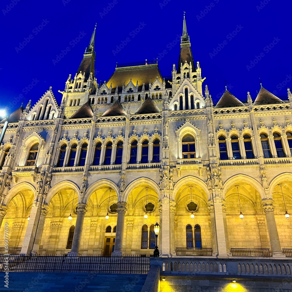 Hungarian Parliament building in Budapest night photography of bright yellow illuminated walls and dark blue sky near the Danube River. High quality 4k footage 03.04.22 Budapest, Hungary