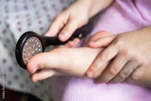 Photos cleaning of the foot and heel with an abrasive stone with pimples, a beauty proc