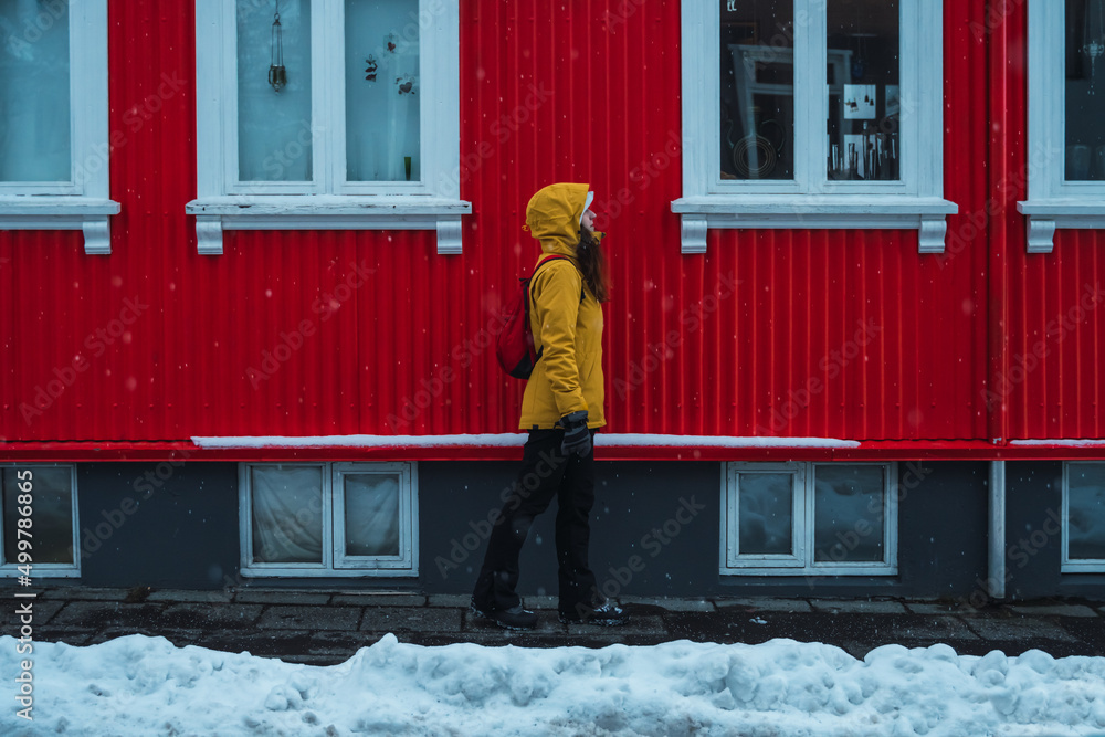 Woman walks alone through the streets of Iceland.