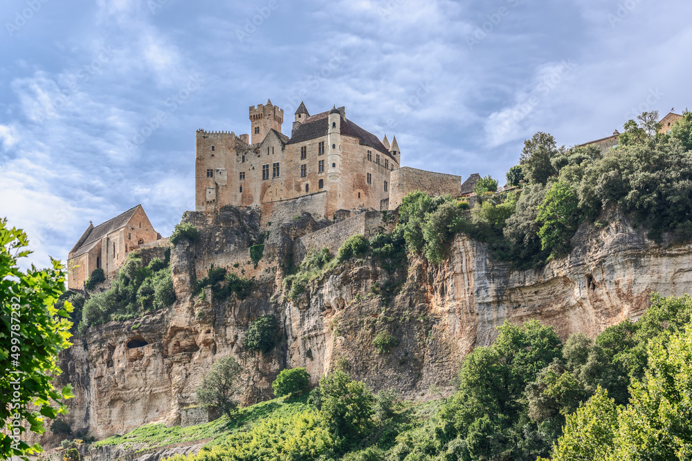 High steep rocky bank of Dordogne River and medieval castle Chateau de Beynac, France