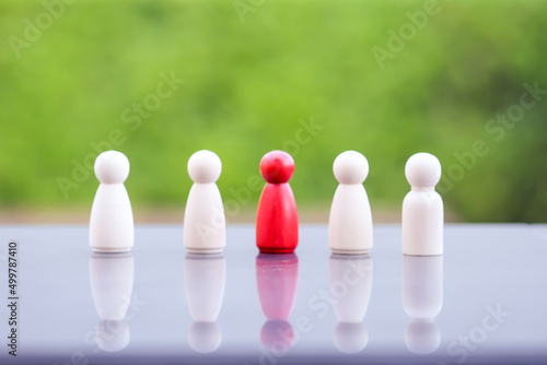 Red person in a crowd of people. Choice of an employee from the crowd. Recruitment and Leader concept.