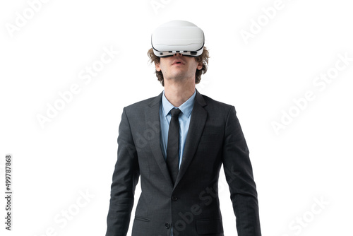 Portrait of young business man in black suit is using augmented reality application in virtual reality glasses isolated on white background. © Jirus