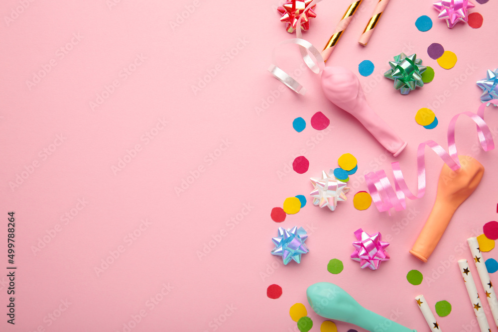 Colorful carnival or party frame of balloons, streamers and confetti on pink background. Space for text