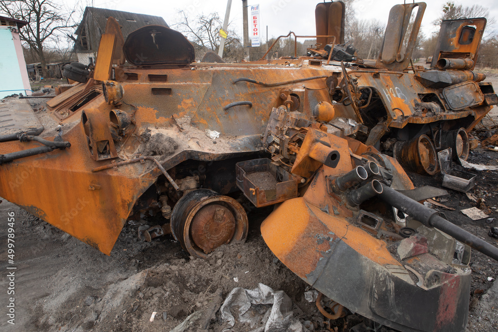 Fototapeta premium Russian infantry fighting vehicle (BMP) in the village of Brovarsky district, Kiev region. Footage after the battle of Ukrainian and Russian soldiers