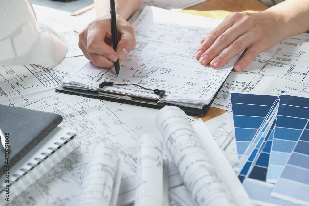 Architects concept, engineer architect designer freelance work on start-up project drawing, construction plan. architect design working drawing sketch plans blueprints and making construction model Architects concept, engineer architect designer freelance work on start-up project drawing, construction plan. architect design working drawing sketch plans blueprints and making construction model