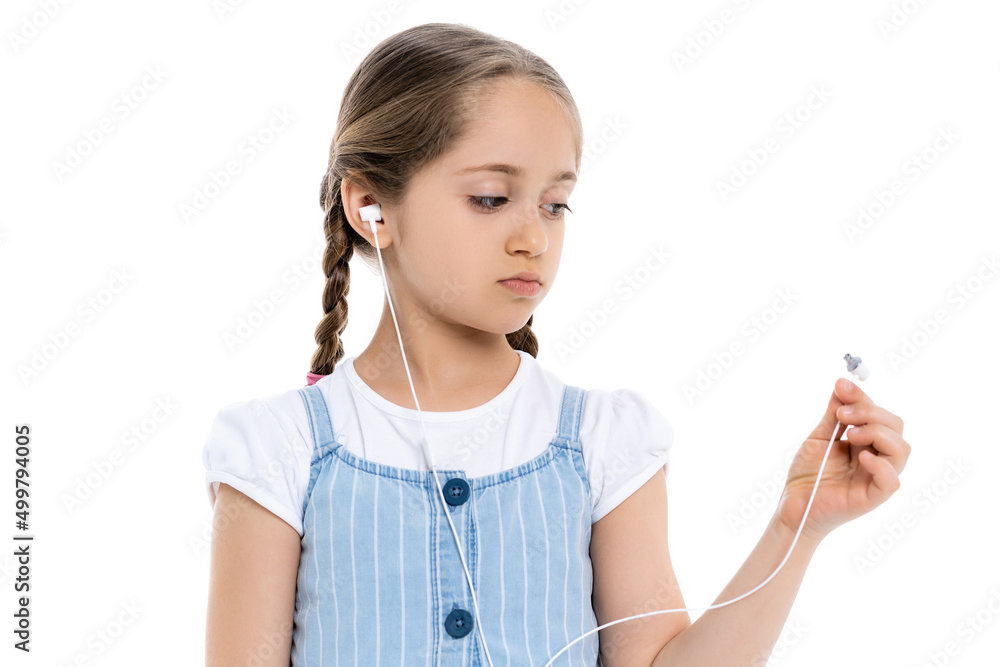 upset girl looking at broken earphone isolated on white. upset girl looking at broken earphone isolated on white.