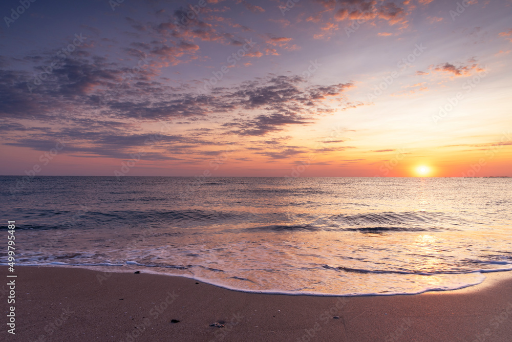 Colorful ocean beach sunrise.
