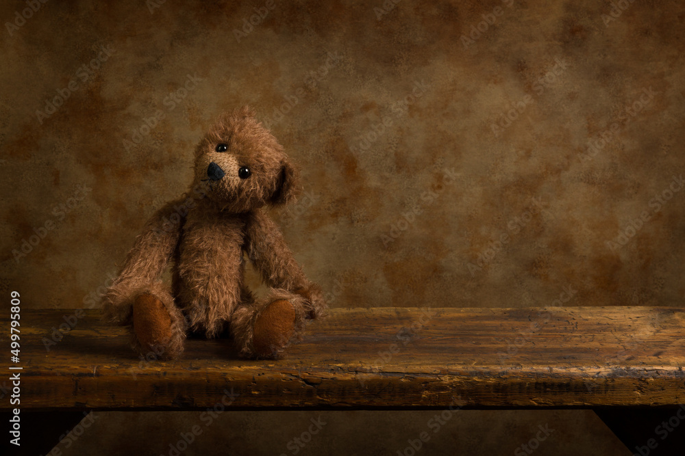 Brown teddy bear on wooden shelf