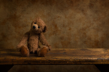 Brown teddy bear on wooden shelf