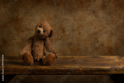 Brown teddy bear on wooden shelf