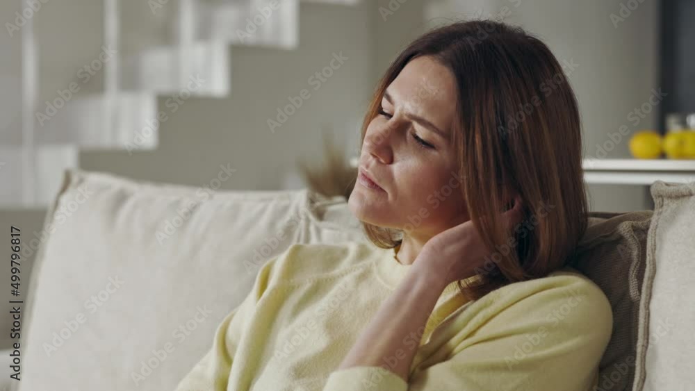 Woman sitting on sofa and thinking about life problems Woman sitting on sofa and thinking about life problems