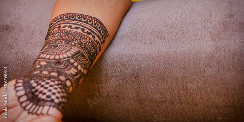 A mehandi design on female hand close up image. photo