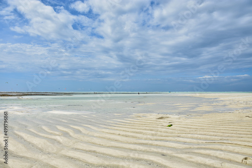 View of the sandy bottom of the Indian Ocean at low tide on the coast on the island of Zanzibar in Tanzania © Anton Perekrestov