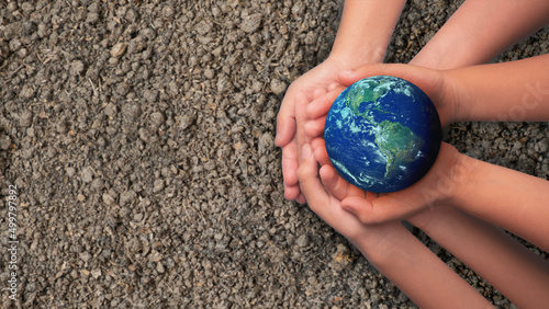 Group of Hands holding earth globe on blue background, International human solidarity day concept, world health day, safe world concept with copy space, Elements of this image furnished by NASA