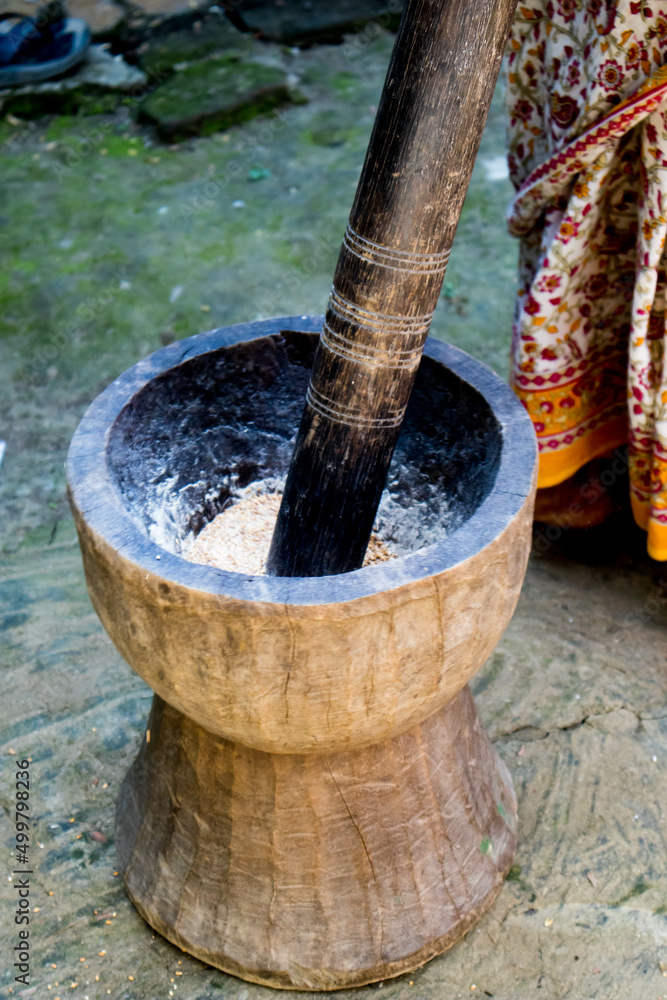 Pesting beans in a Ukhal musal (Mortal and Pestle) Pesting beans in a Ukhal musal (Mortal and Pestle)