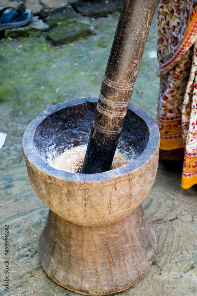 Pesting beans in a Ukhal musal (Mortal and Pestle) Pesting beans in a Ukhal musal (Mortal and Pestle)