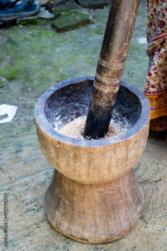 Pesting beans in a Ukhal musal (Mortal and Pestle) © Sushanta