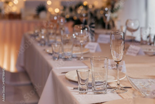 Serving a festive wedding table. Glass goblets close-up.