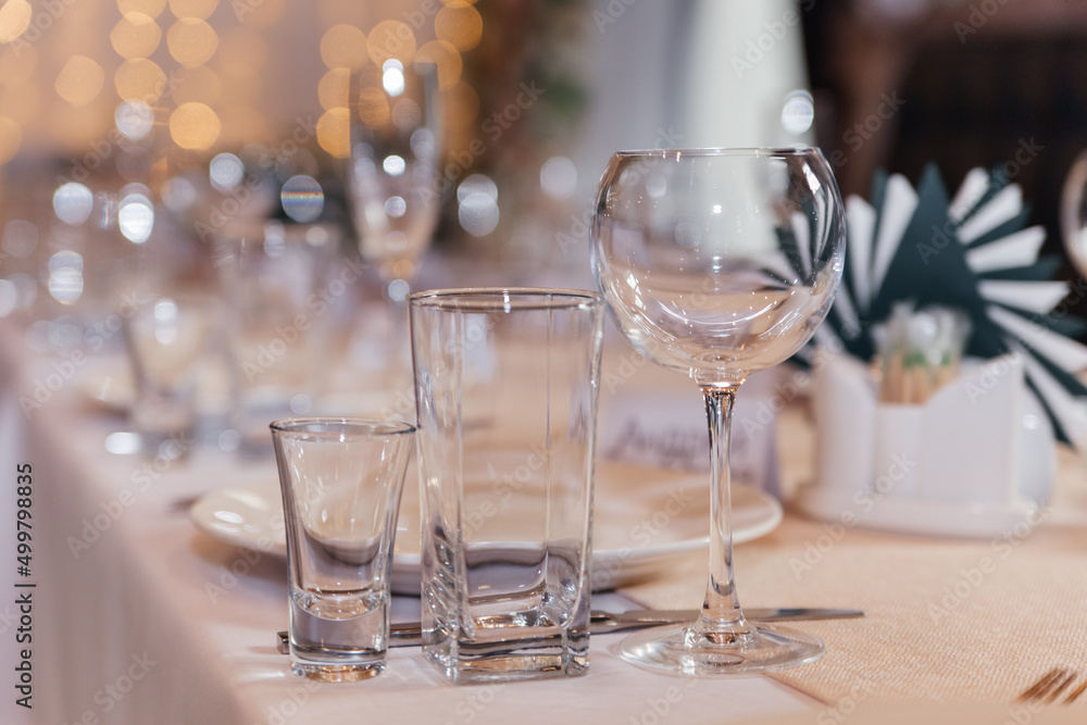 Serving a festive wedding table. Glass goblets close-up. Serving a festive wedding table. Glass goblets close-up.