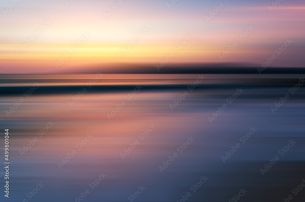Beautiful sunset background at the beach motion blur
