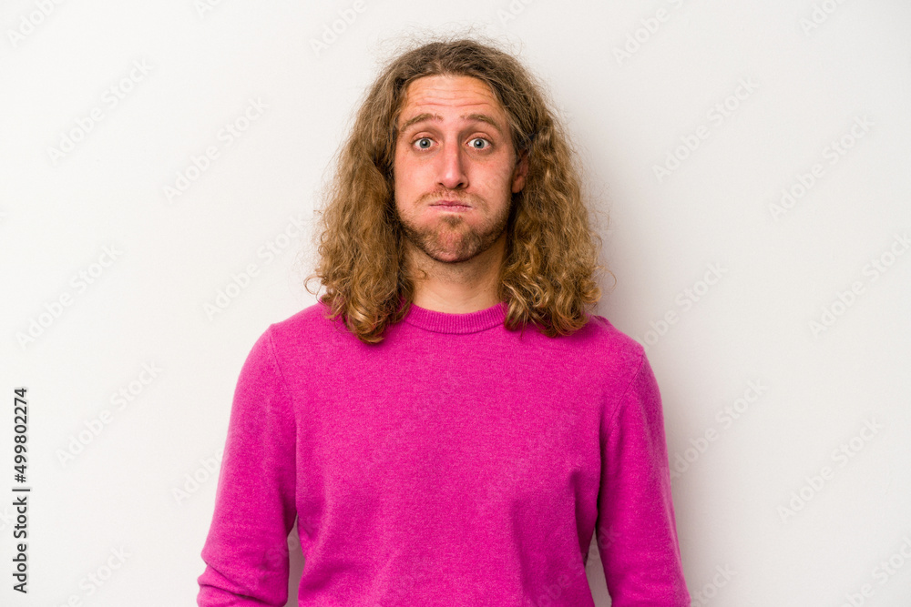 Young caucasian man isolated on white background blows cheeks, has tired expression. Facial expression concept. Young caucasian man isolated on white background blows cheeks, has tired expression. Facial expression concept.