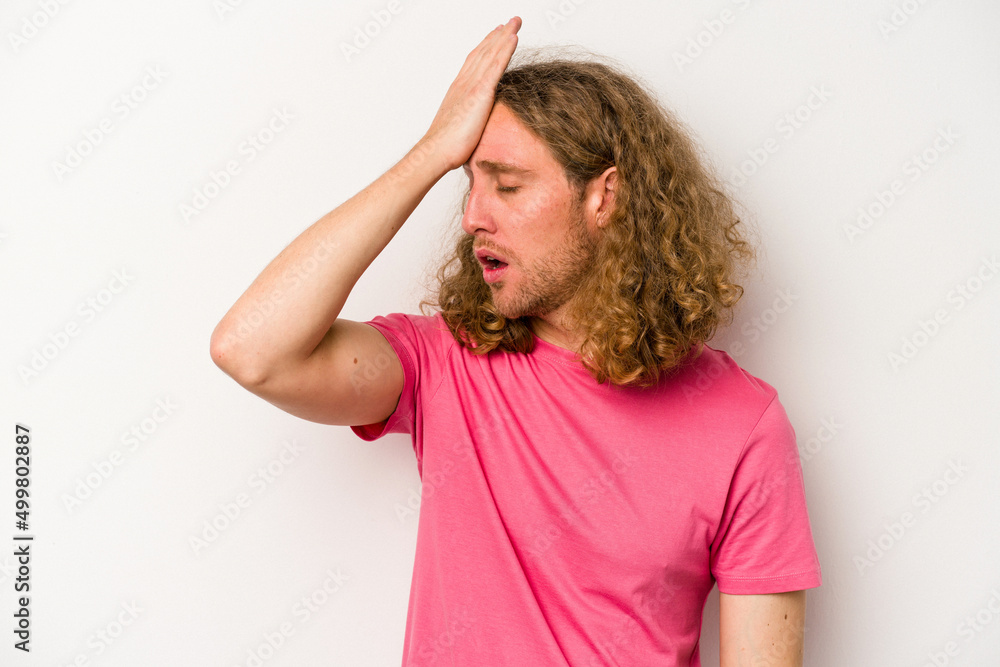 Young caucasian man isolated on white background forgetting something, slapping forehead with palm and closing eyes.