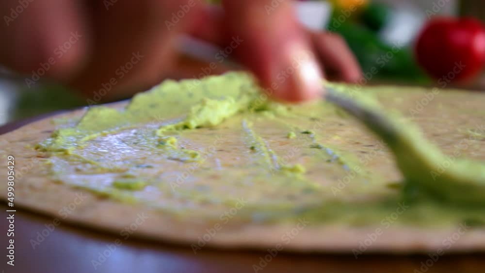 Avocado Paste Spreading On Pita Bread. Close Up, Slide Shot Avocado Paste Spreading On Pita Bread. Close Up, Slide Shot