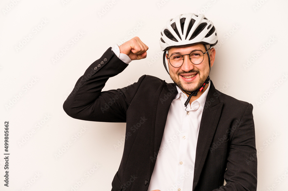 Business hispanic man wearing a helmet bike isolated on white background raising fist after a victory, winner concept. Business hispanic man wearing a helmet bike isolated on white background raising fist after a victory, winner concept.