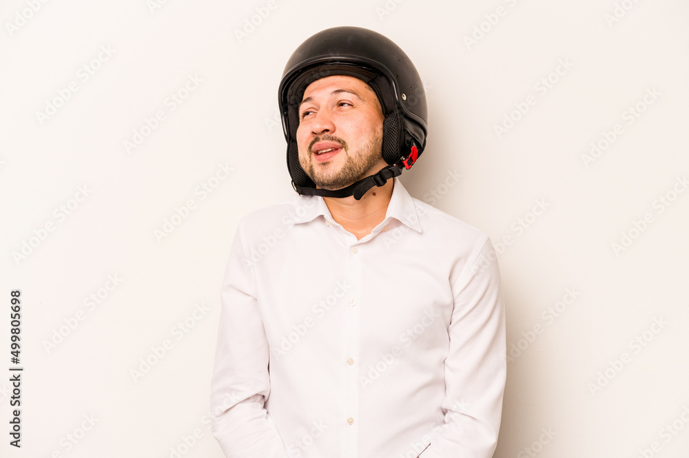 Hispanic business man going to work with motorcycle isolated on white background dreaming of achieving goals and purposes Hispanic business man going to work with motorcycle isolated on white background dreaming of achieving goals and purposes