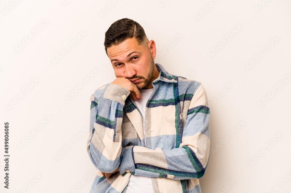 Young hispanic man isolated on white background tired of a repetitive task. Young hispanic man isolated on white background tired of a repetitive task.