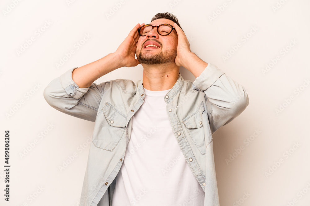 Young hispanic man isolated on white background laughs joyfully keeping hands on head. Happiness concept. Young hispanic man isolated on white background laughs joyfully keeping hands on head. Happiness concept.