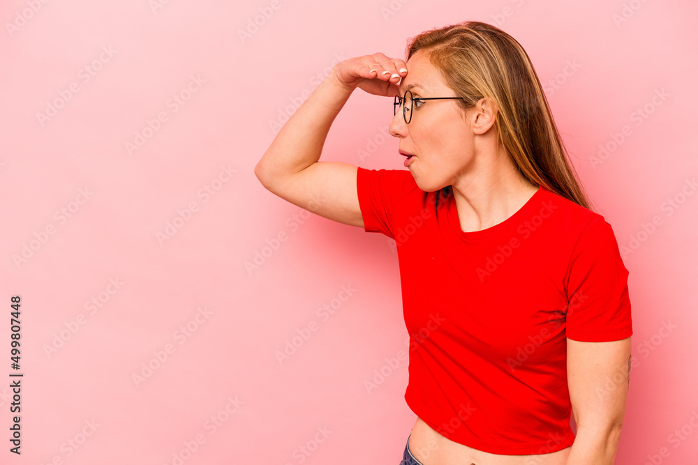 Young caucasian woman isolated on pink background looking far away keeping hand on forehead. Young caucasian woman isolated on pink background looking far away keeping hand on forehead.