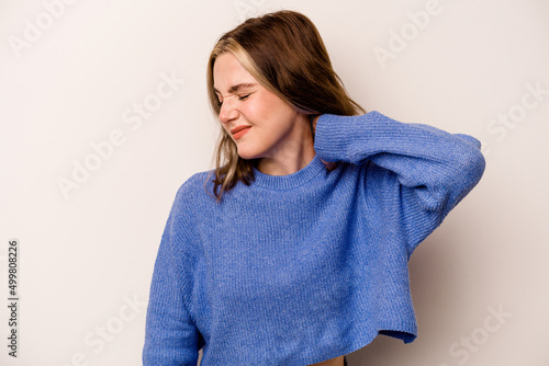 Young caucasian woman isolated on white background suffering neck pain due to sedentary lifestyle.