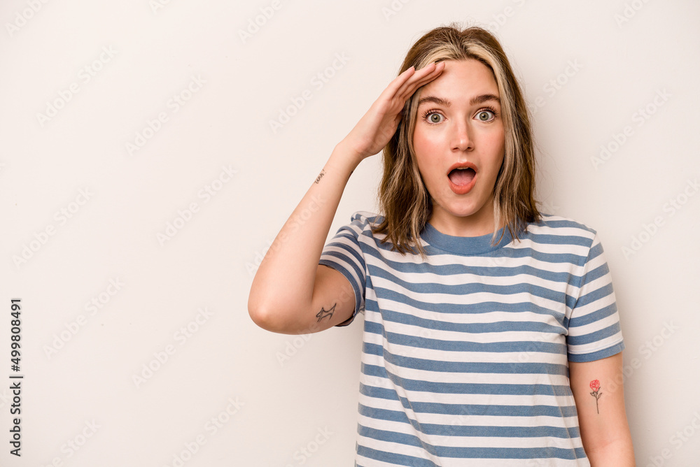 Young caucasian woman isolated on white background shouts loud, keeps eyes opened and hands tense. Young caucasian woman isolated on white background shouts loud, keeps eyes opened and hands tense.